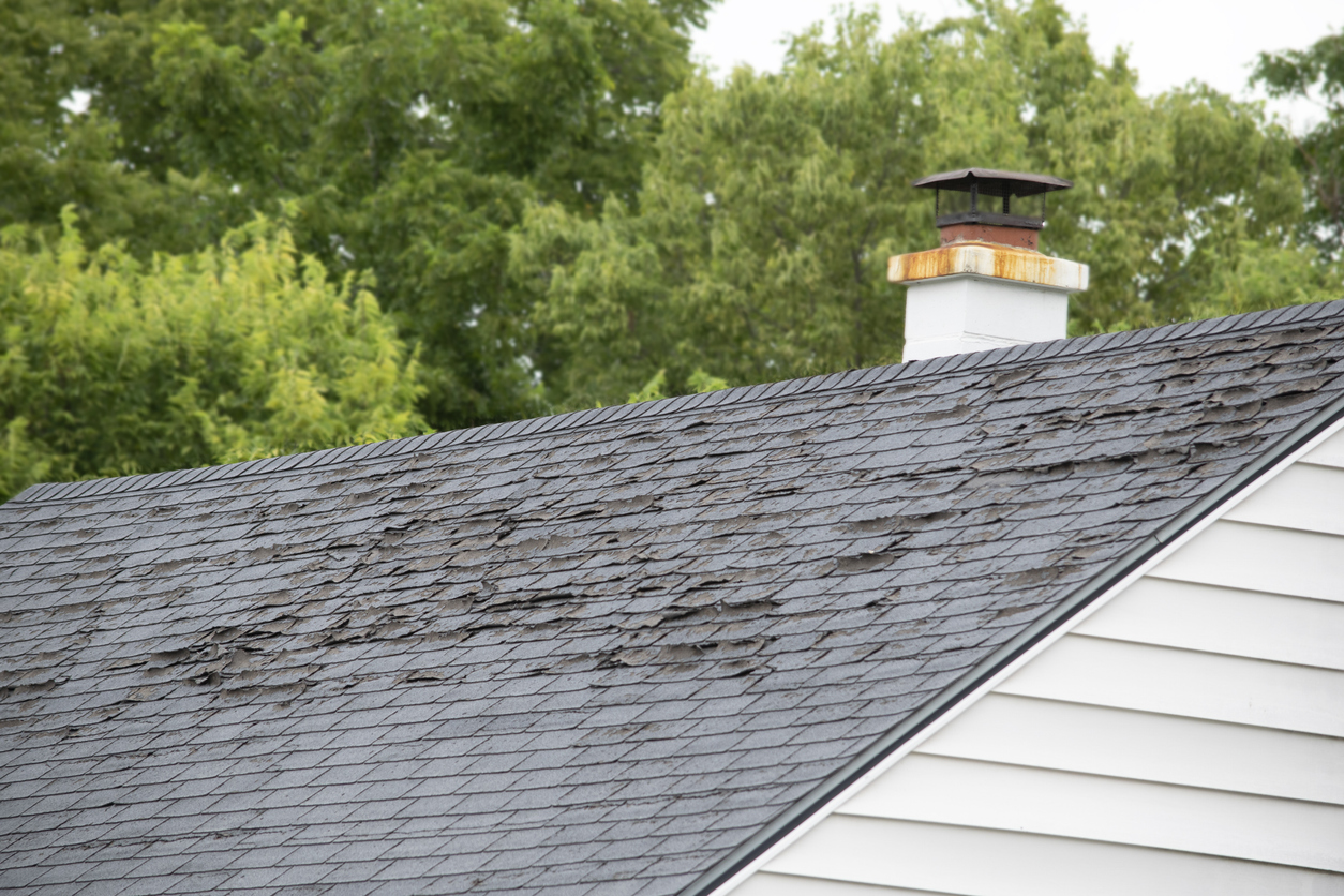 Damage to asphalt and asbestos shingles, gutter systems, chimney and roof flashing on residential home; signs to replace your home's roof