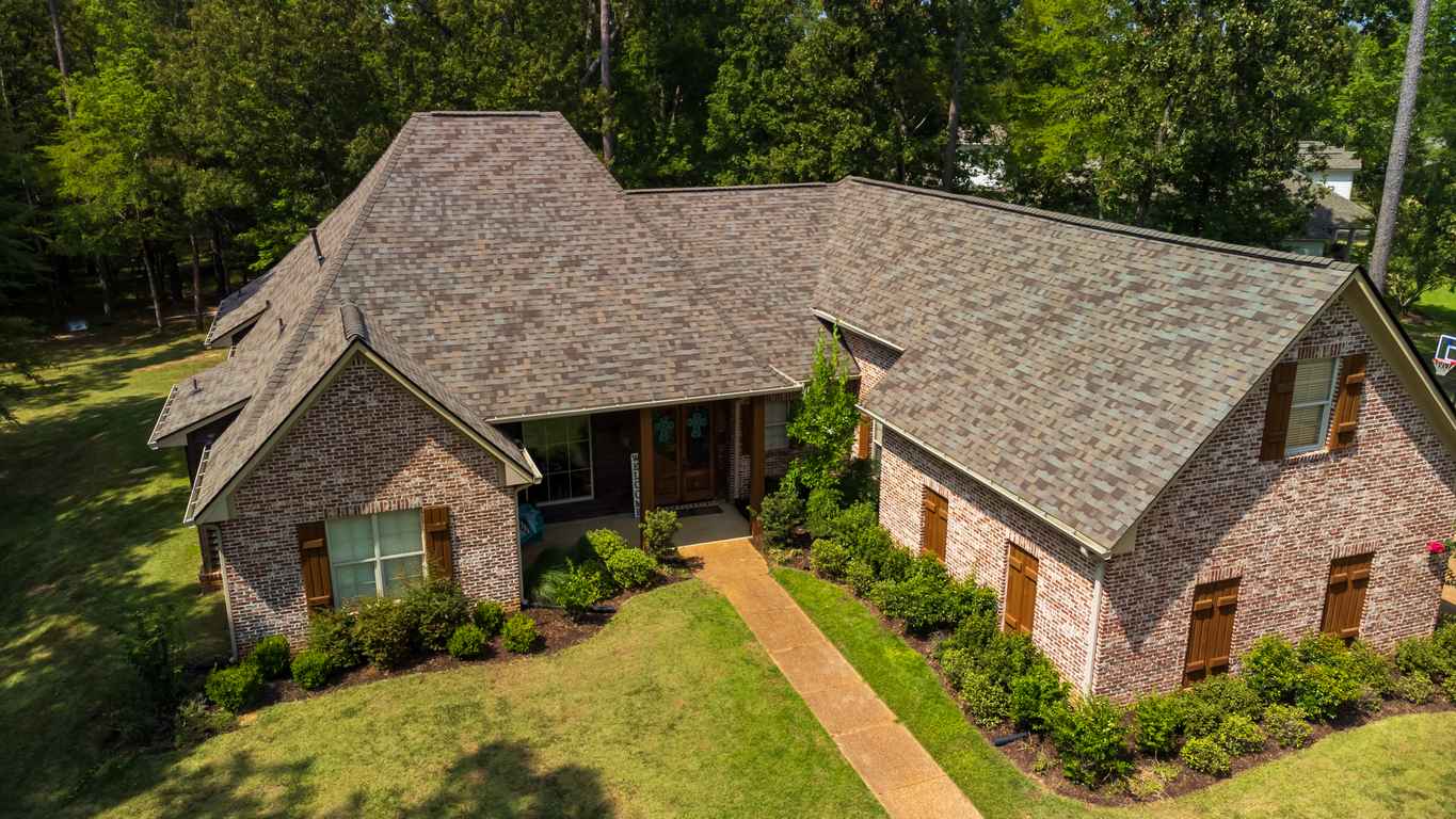 Suburban house with newly installed shingle roof